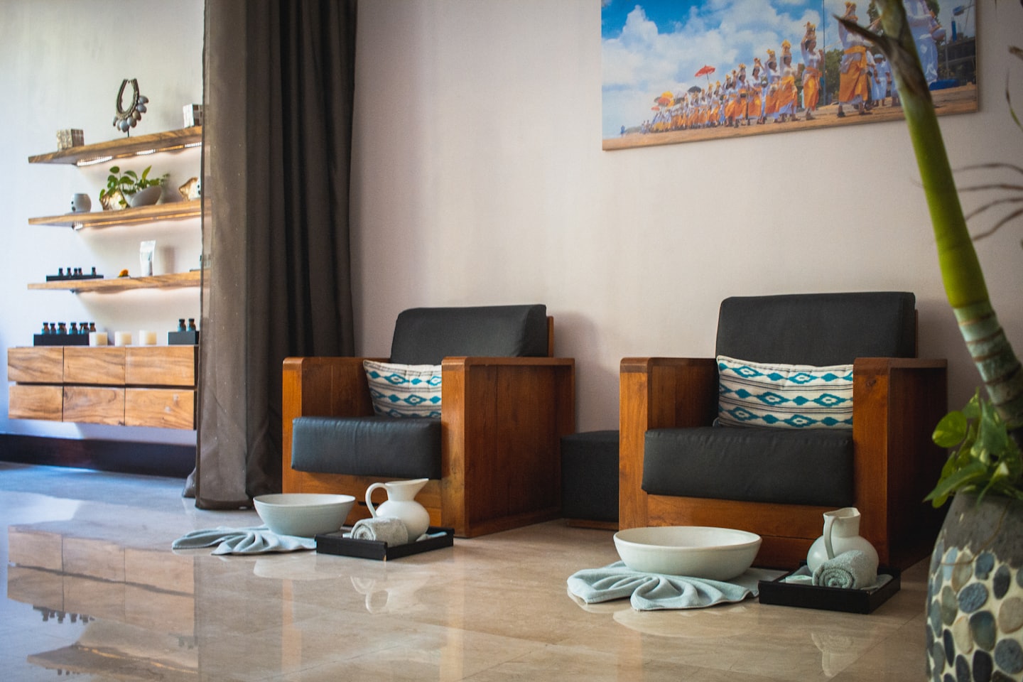 Two armchairs with foot baths arranged in a spa room.
